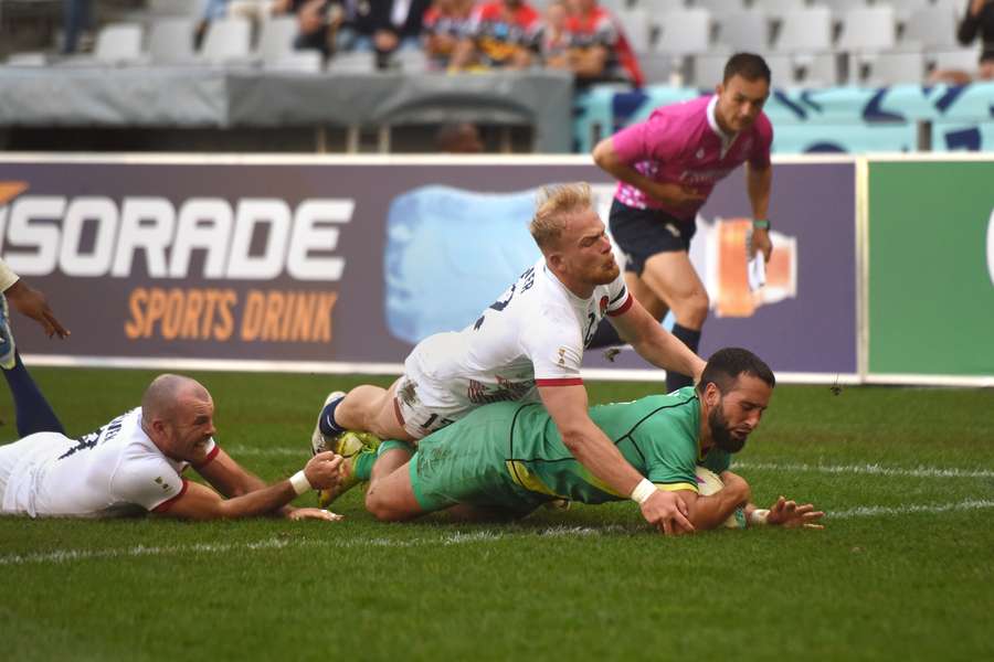 Mark Roche of Ireland scores a try against England during the Rugby World Cup Sevens tournament.