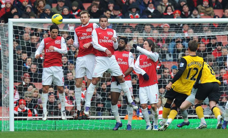 Pedersen curls a free-kick over Arsenal's wall. Pedersen curls a free-kick over Arsenal's wall.