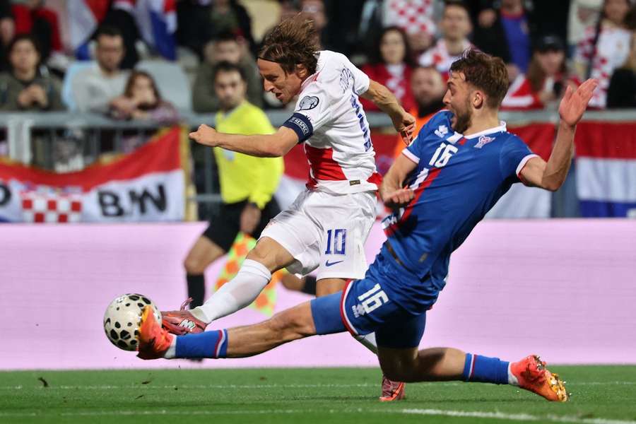 Croatia's midfielder Luka Modric (L) fights for the ball with Faroe's defender Gunnar Vatnhamar