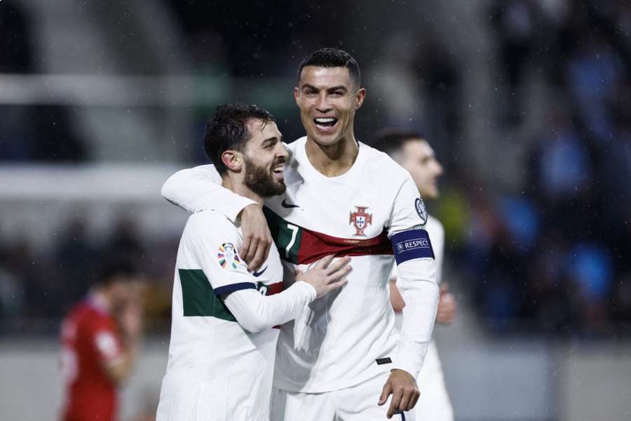 Cristiano Ronaldo is congratulated by Bernardo Silva after netting against Luxembourg