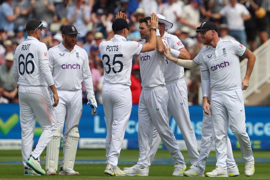 England's James Anderson (centre right) celebrates with teammates after bowling Australia's wicket keeper Alex Carey on day three