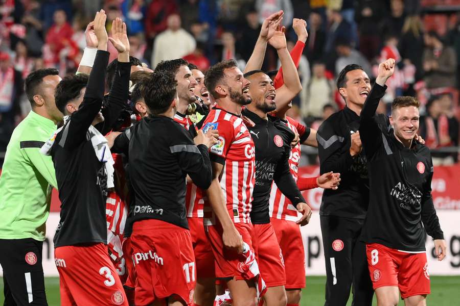 Girona celebrate a famous win over Real Madrid at full-time