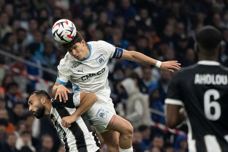 Marseille's Leonardo Balerdi goes for a header against Angers