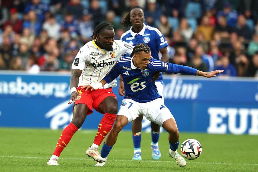 Diego Moreira, right, fights for the ball with Lens’ M’Bala Nzola