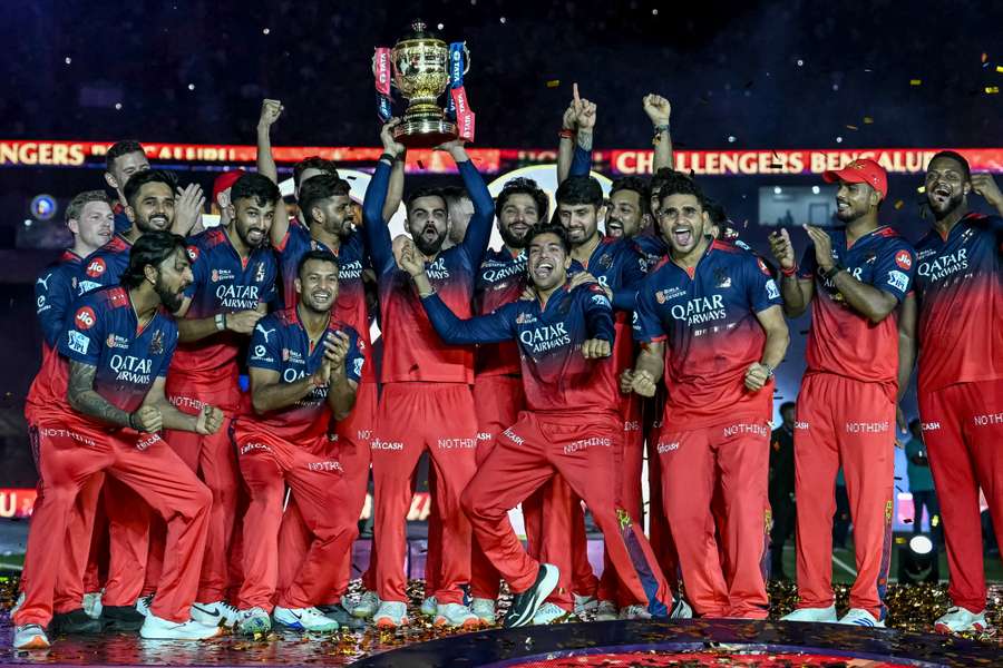 Virat Kohli and his RCB teammates lift the IPL trophy for the first time after winning the 2025 season. Virat Kohli and his RCB teammates lift the IPL trophy for the first time after winning the 2025 season.