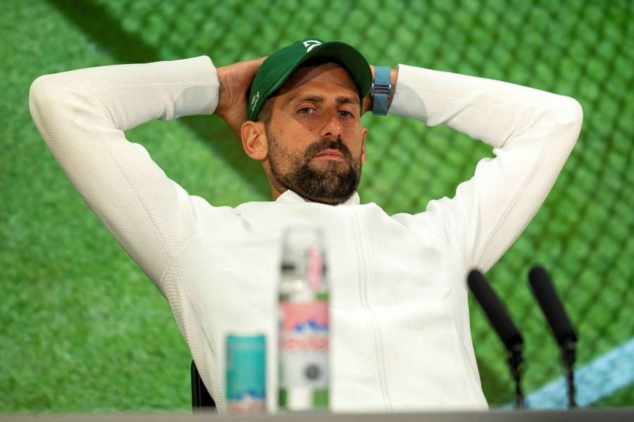 Novak Djokovic reacts as he speaks to the media during a post-match press conference after his defeat to Jannik Sinner at Wimbledon