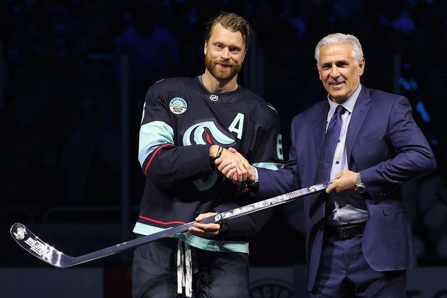 Ron Francis gratuluje Adamovi Larssonovi k tisícemu zápasu v NHL.