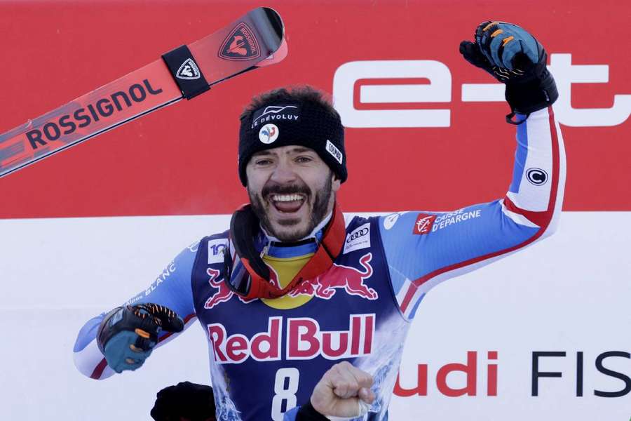 Sarrazin celebrates on the podium after winning the men's downhill at Kitzbuhel
