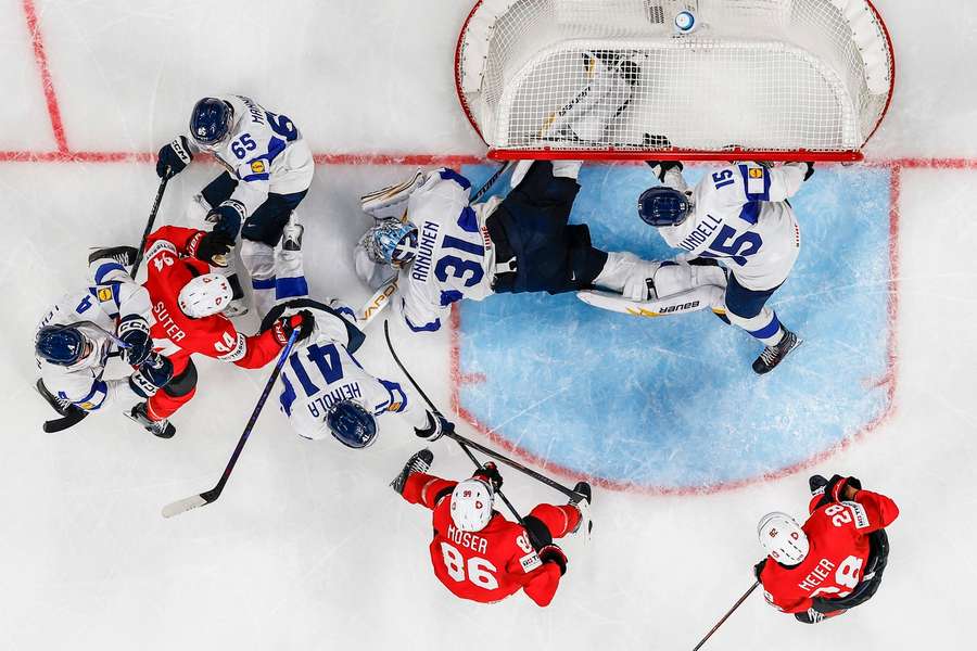 Annunen dives on the loose puck as Switzerland attack