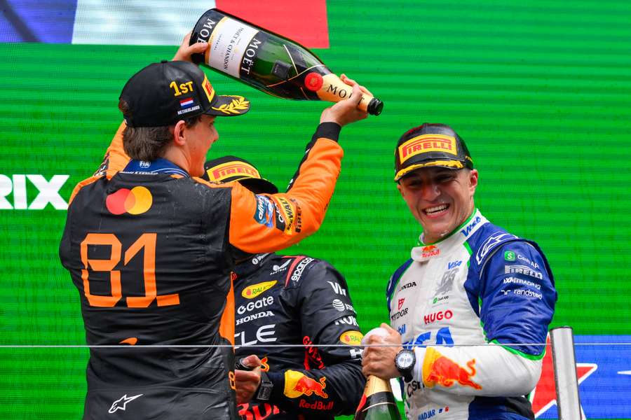 Oscar Piastri celebrates the maiden podium of Racing Bulls rookie driver Isack Hadjar.