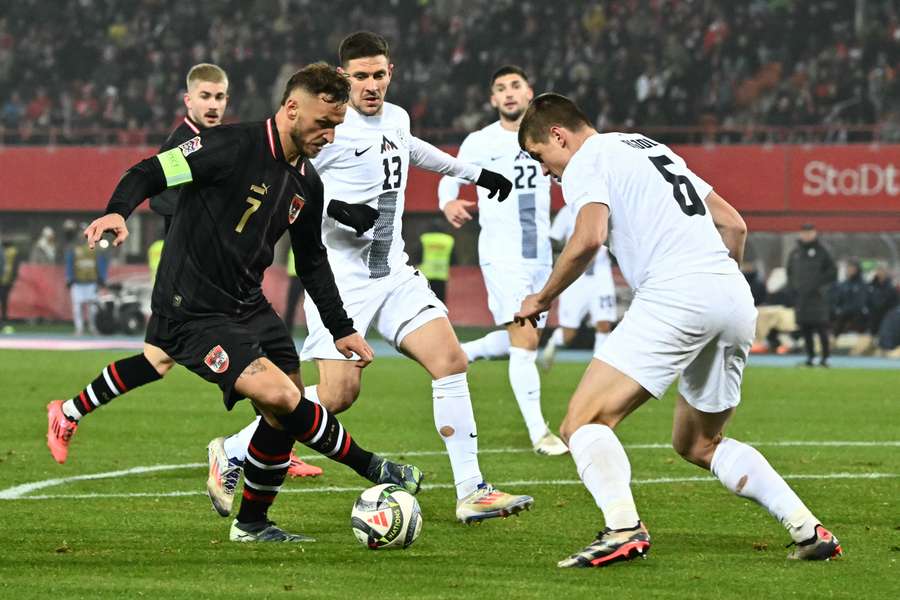 Marko Arnautovic and Slovenia defender Jaka Bijol vie for the ball 