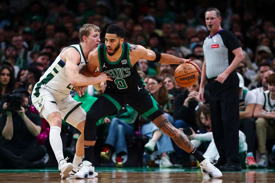 Boston's Jayson Tatum holds off Milwaukee's AJ Green on his way to 31 points in the Celtics win over the Bucks