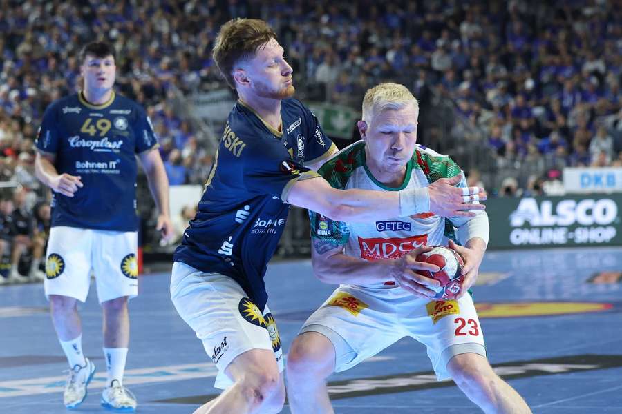 Bergischer's Johannes Wasielewski battles for the ball with Magdeburg's Magnus Saugstrup