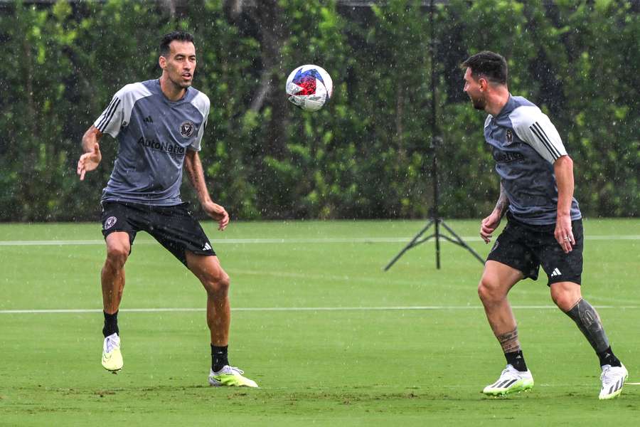 Inter Miami's Lionel Messi, right, and Sergio Busquets train in the rain at Fort Lauderdale, Florida