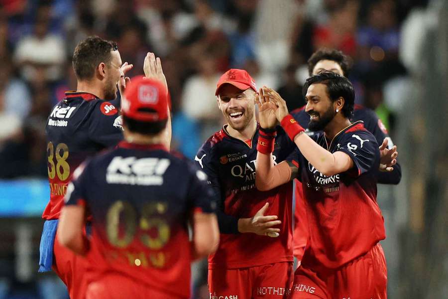 Royal Challengers Bengaluru's Krunal Pandya celebrates with teammates after taking the wicket of Mumbai Indians' Will Jacks
