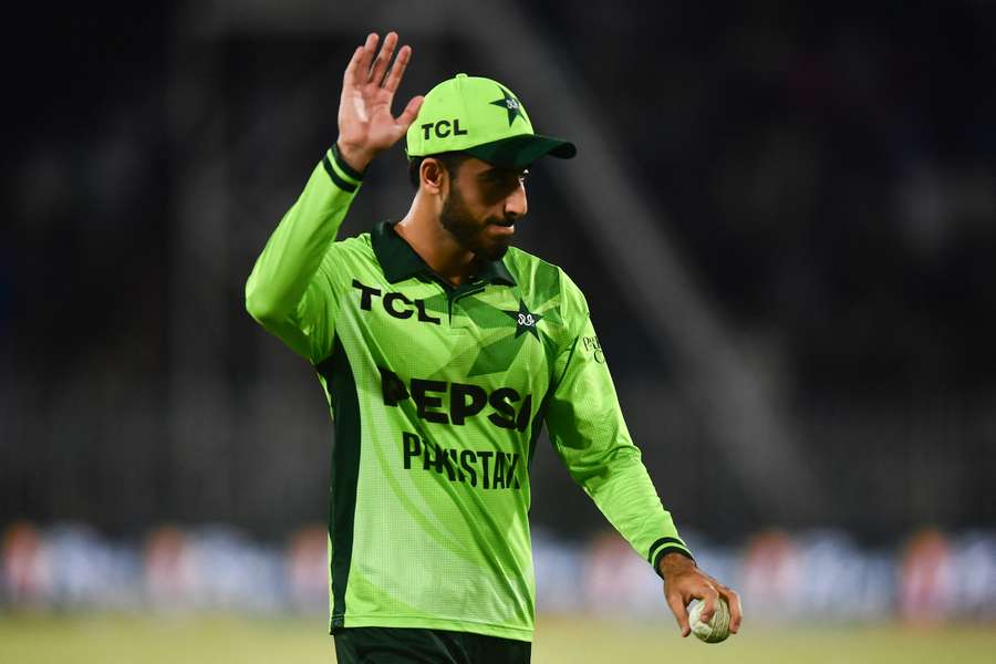 Arafat Minhas leaves the field with the match ball. Arafat Minhas leaves the field with the match ball.