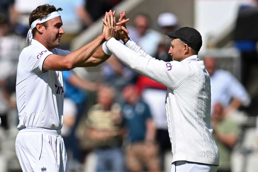 England's Stuart Broad (L) celebrates with Joe Root (R) after taking his 600th wicket