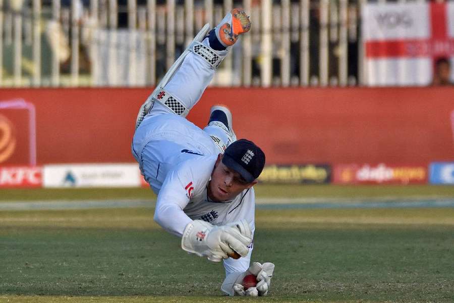 Ollie Pope dives to take a catch to dismiss Pakistan's Zahid Mahmood during the match.