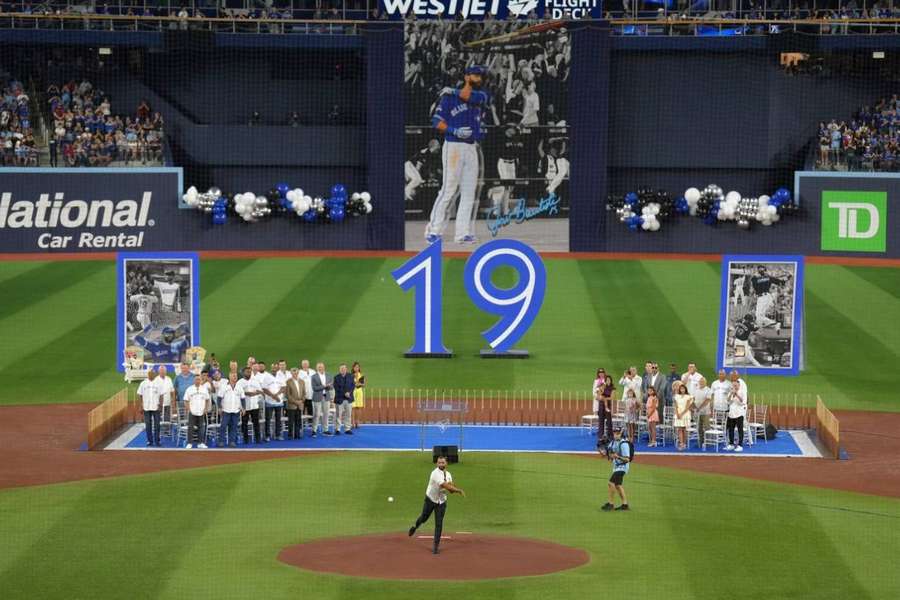 Jose Bautista throws the ceremonial first pitch after his name was unveiled on the Jays' Level of Excellence