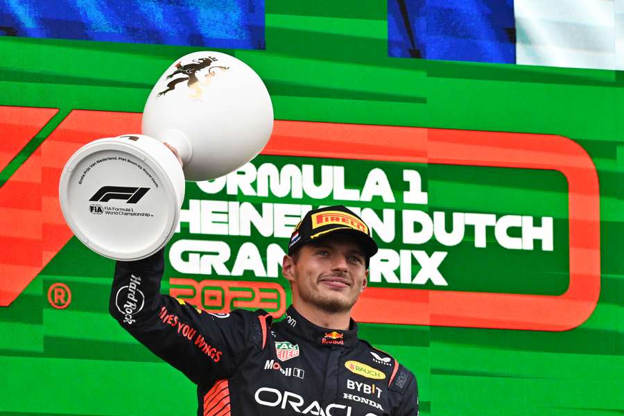 Red Bull's Max Verstappen celebrates with the trophy on the podium