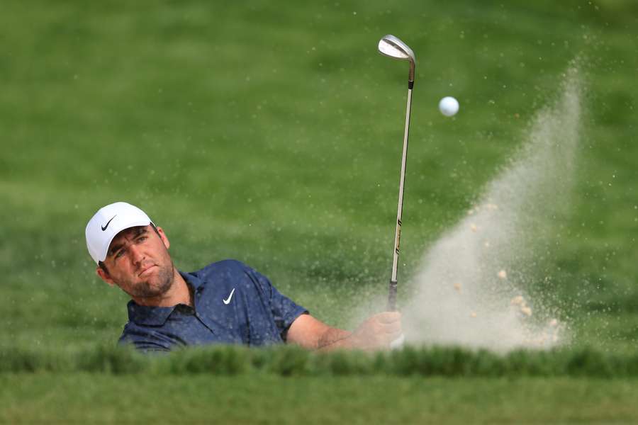 Scottie Scheffler plays a shot from the bunker during a practice round ahead of the PGA Championship at Oak Hill