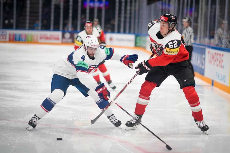 Players from the USA and Austria battle on the ice