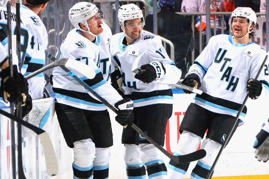 Dylan Guenther (centre) celebrates his first career hat trick (2026)