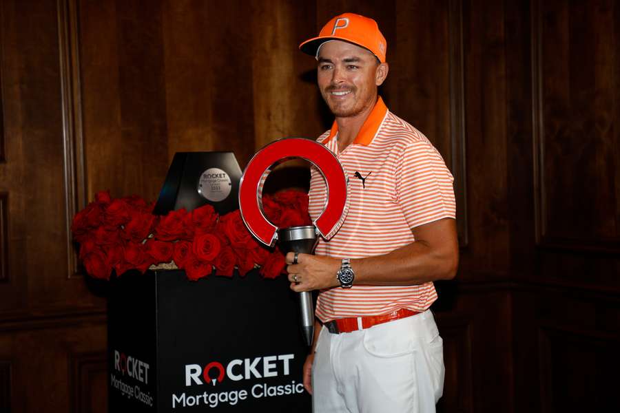 Rickie Fowler of the United States poses with the trophy after winning the Rocket Mortgage Classic