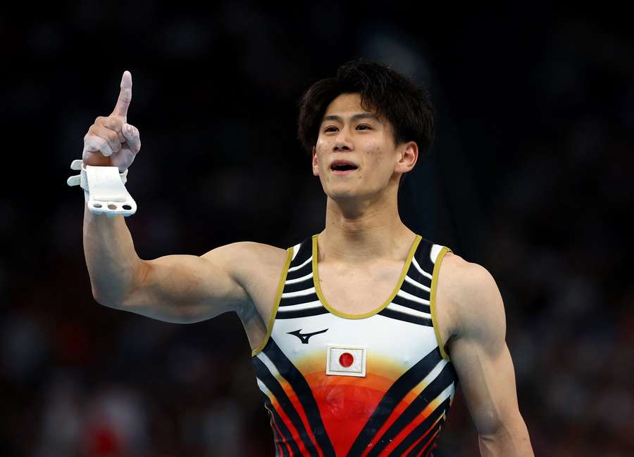 Daiki Hashimoto of Japan reacts after his performance on the horizontal bar