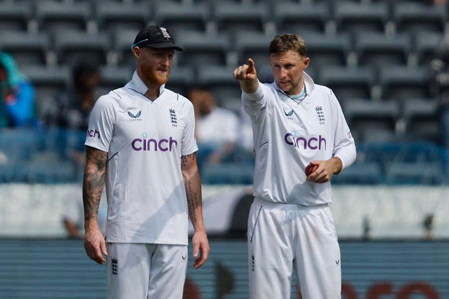 Joe Root, right, and Ben Stokes discuss England's field