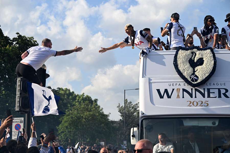 Richarlison of Tottenham Hotspur high-fives a fan during the parade