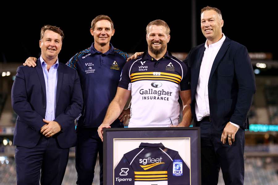 James Slipper is presented with a commemorative guernsey to mark his record-breaking appearance. James Slipper is presented with a commemorative guernsey to mark his record-breaking appearance.