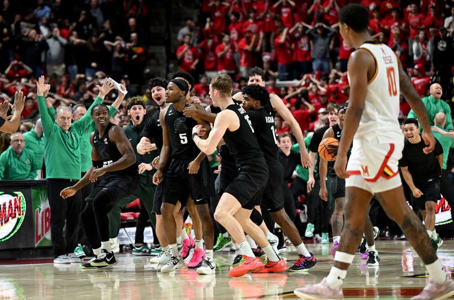 Michigan State teammates surround Tre Holloman (#5) after he hits the game-winning halfcourt shot to beat Maryland 58-55. (February 2025)