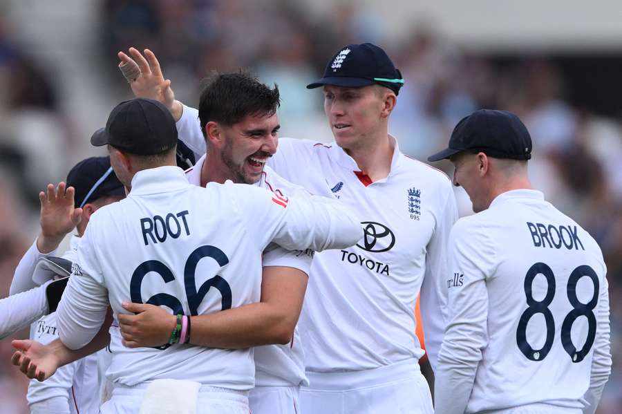 Josh Tongue of England celebrates with Joe Root, Zac Crawley and Harry Brook after dismissing Ravindra Jadeja