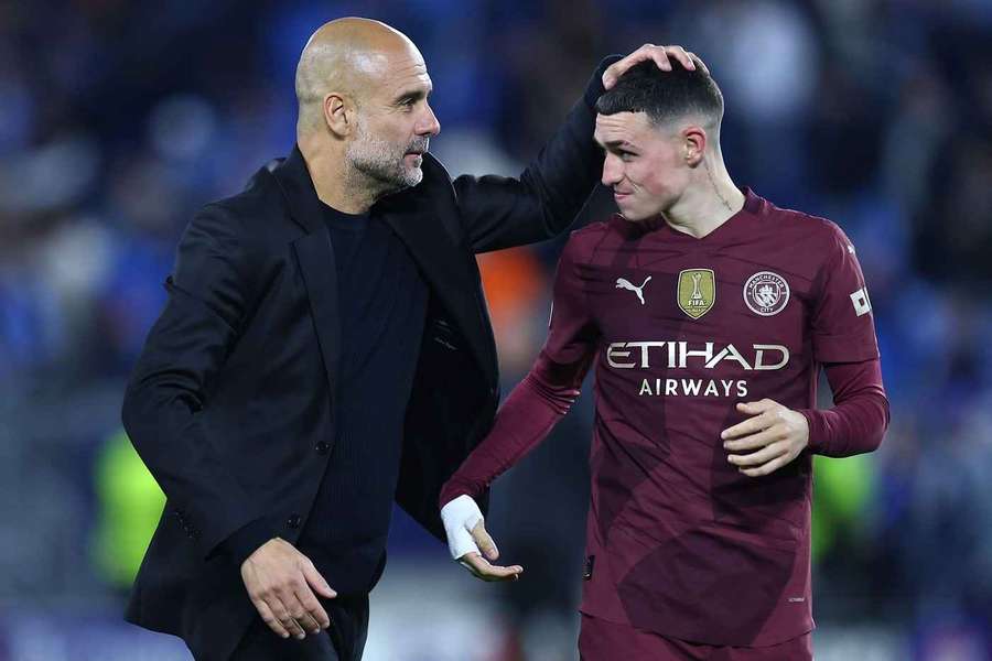 Pep Guardiola (left) speaks with Man City's Player of the Year Phil Foden