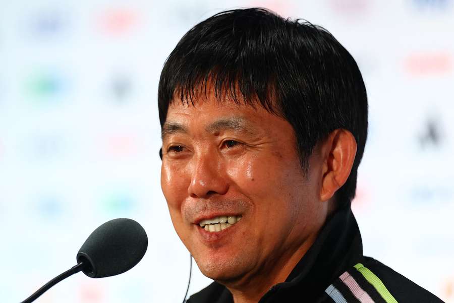 Hajime Moriyasu shares a lighter moment with reporters at a MD -1 press conference.