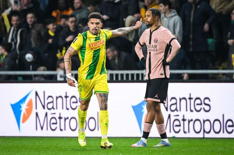 Douglas Augusgo of Nantes celebrates his goal and Bradley Barcola of PSG looks dejected