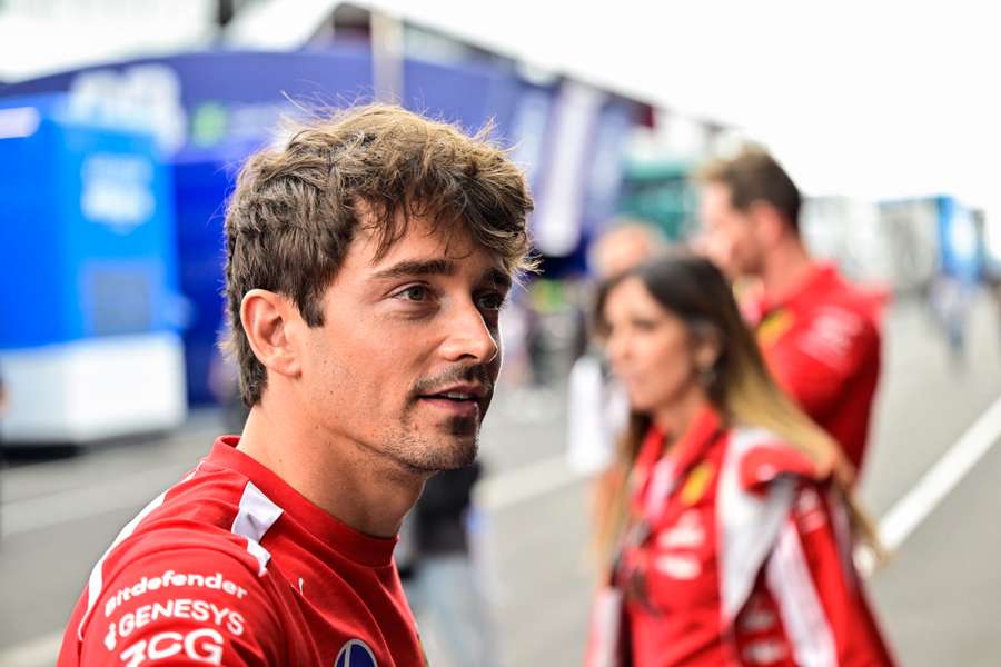 Charles Leclerc walks through the paddock in Hungary