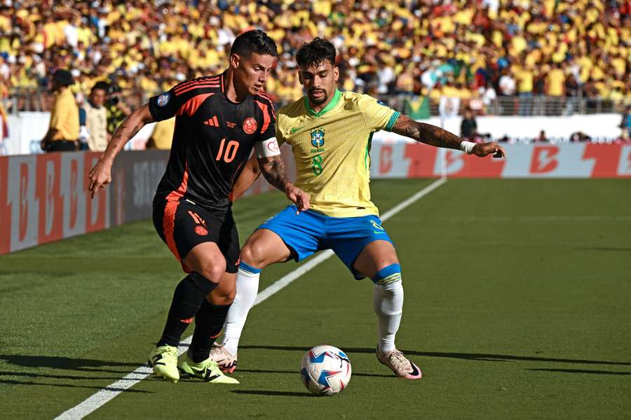 James Rodriguez and Lucas Paqueta battle for possession 