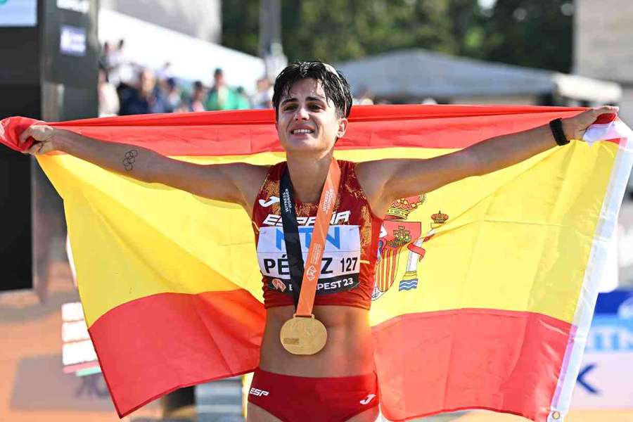 María Perez holds aloft the Spanish flag after winning gold in the women's 20km race walk