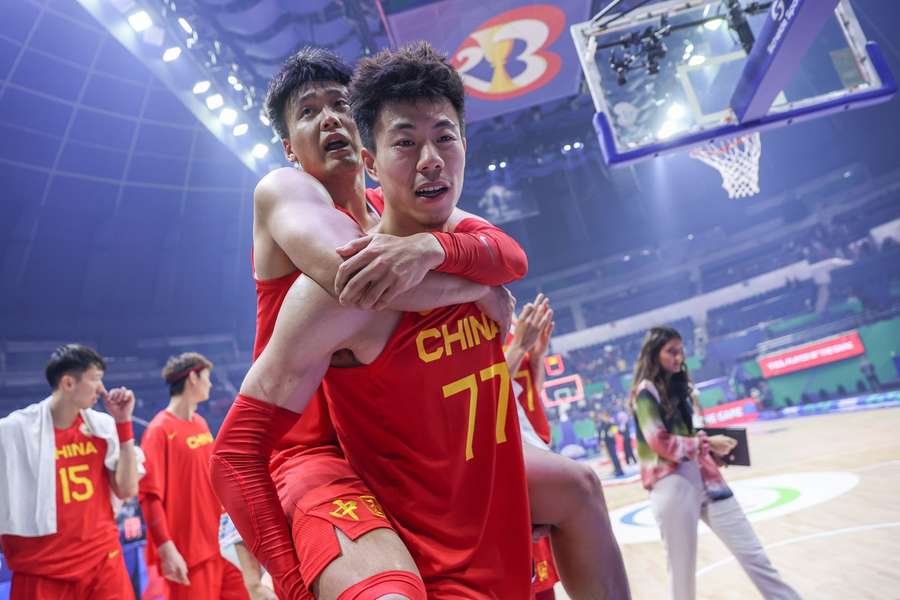 China's players celebrate after their win over Angola