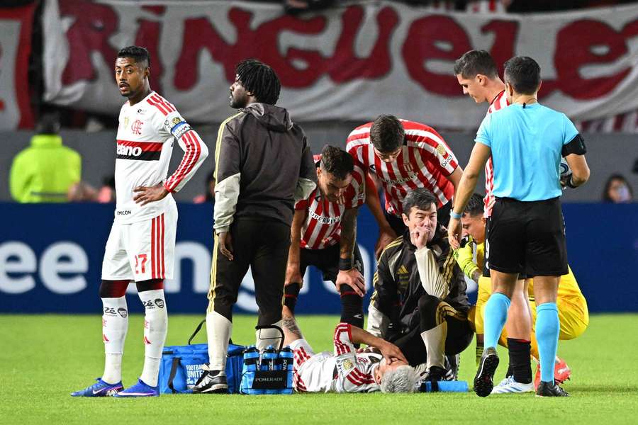 Flamengo's Giorgian de Arrascaeta receives medical attention after sustaining an injury