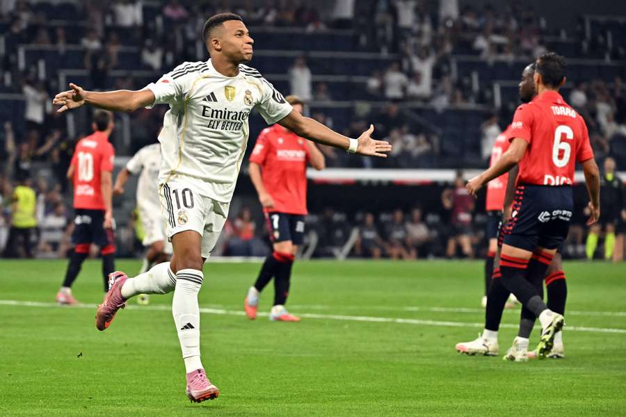 Real Madrid's French forward #10 Kylian Mbappe celebrates scoring the opening goal from the penalty spot