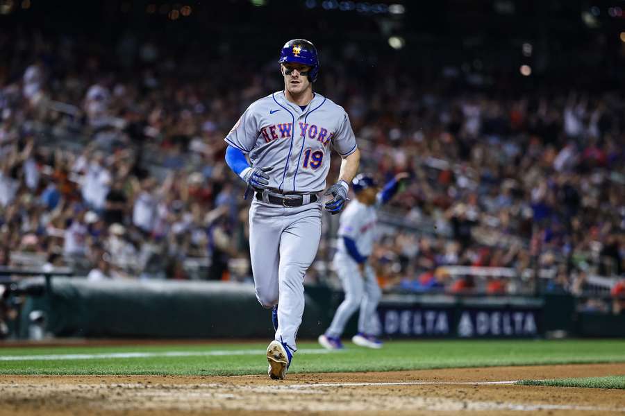 Mark Canha scores a run against the Washington Nationals during the sixth inning at Nationals Park