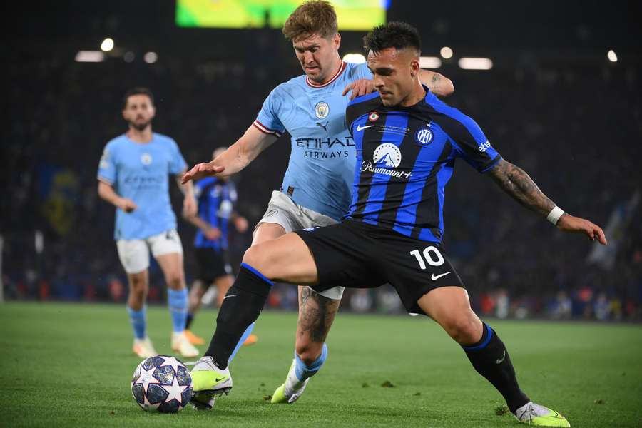 John Stones fights for the ball with Lautaro Martinez