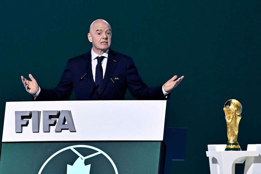 FIFA President Gianni Infantino speaks during the congress next to the World Cup trophy