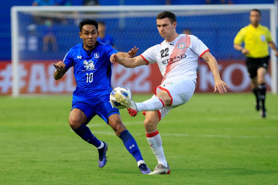 Melbourne City's Curtis Good in action with BG Pathum United's Teerasil Dangda
