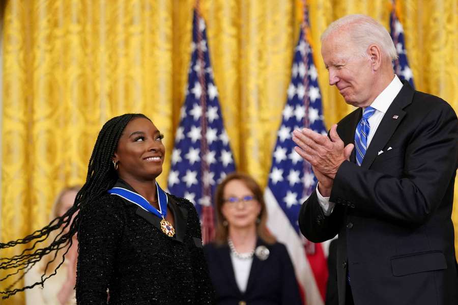 Joe Biden applauds after awarding the Presidential Medal of Freedom to Olympic gymnast Simone Biles