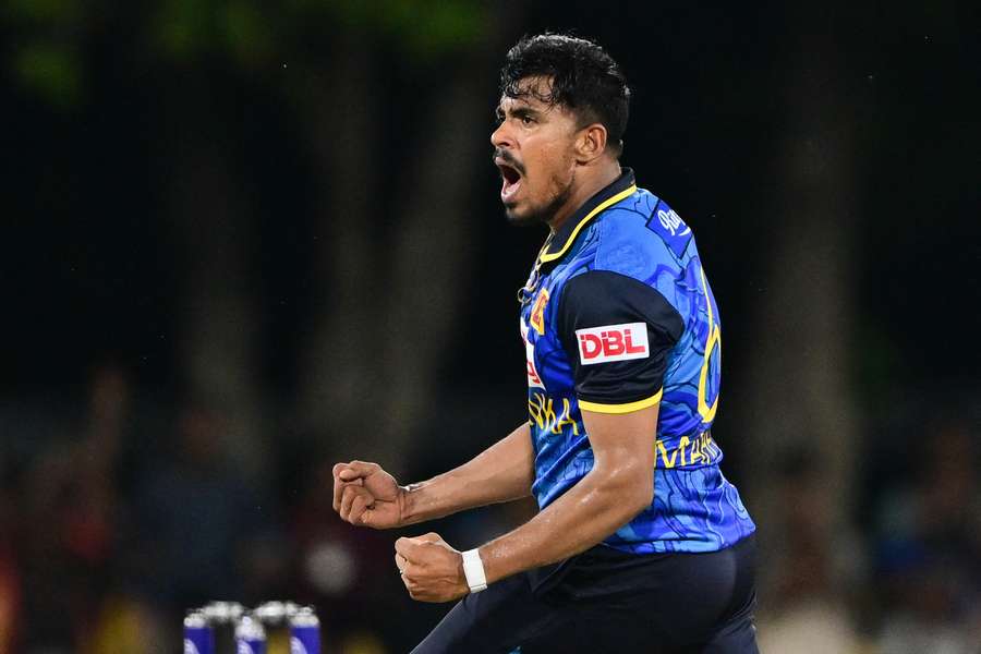 Sri Lanka's Maheesh Theekshana celebrates after taking the wicket of New Zealand's Will Young