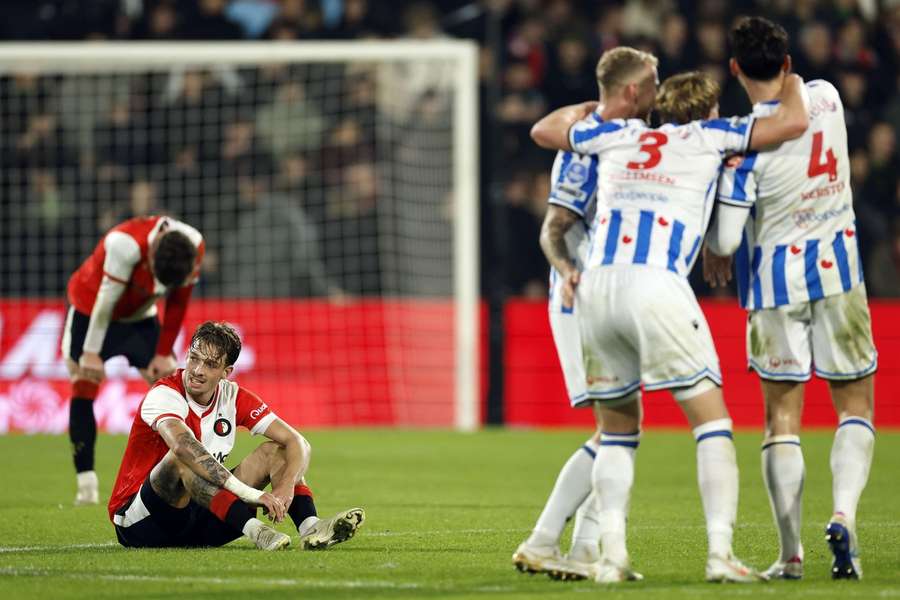 Heerenveen celebrate their win over Feyenoord with Feyenoord's Luciano Valente (L) looking on Heerenveen celebrate their win over Feyenoord with Feyenoord's Luciano Valente (L) looking on